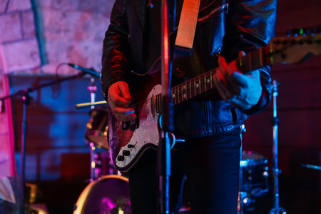Man playing electric guitar on stage, closeupの写真素材