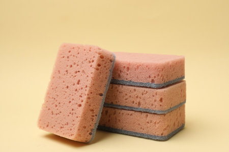 Pink kitchen sponges on beige background, closeupの写真素材