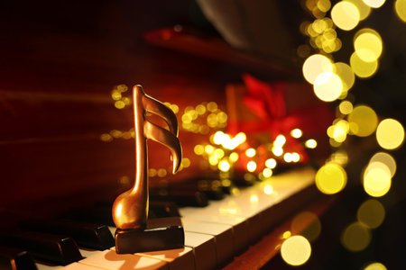 Christmas atmosphere. Music note on piano against black background, closeup with space for text. Bokeh effectの写真素材