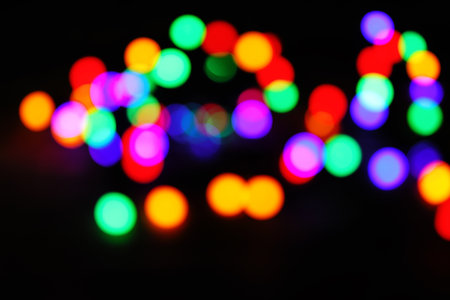 Blurred view of bright lights on dark background. Bokeh effectの写真素材