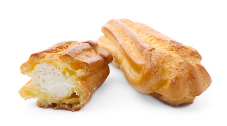 Tasty eclairs with whipped cream isolated on white