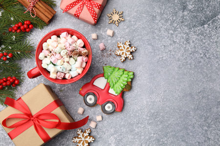 Tasty gingerbread cookies, cup of drink and Christmas decor on light gray table, flat lay. Space for textの写真素材