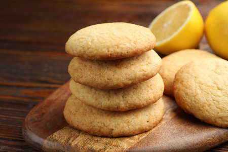 Tasty lemon cookies and fruits on wooden table, closeupの写真素材