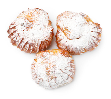 Tasty profiteroles with powdered sugar isolated on white, top viewの写真素材