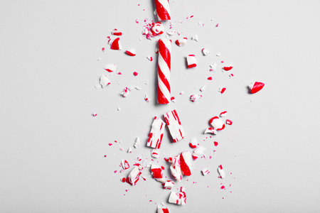 Crushed candy cane on gray background, flat lay. Christmas treatの写真素材