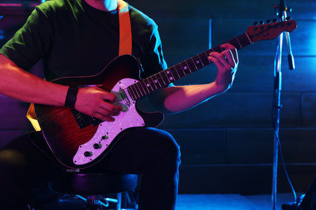 Man playing electric guitar on stage, closeupの写真素材