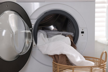 Modern washing machine and clothes indoors, closeupの写真素材