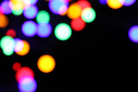 Bright Christmas lights on dark background, space for text. Bokeh effectの写真素材
