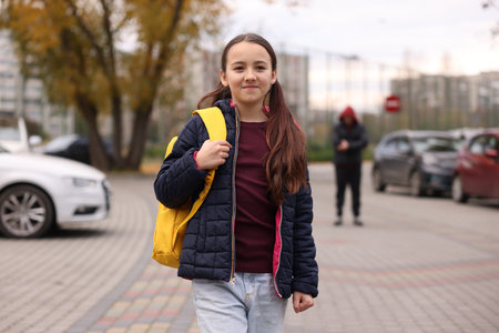 Little girl with backpack walking outdoors. Childの写真素材