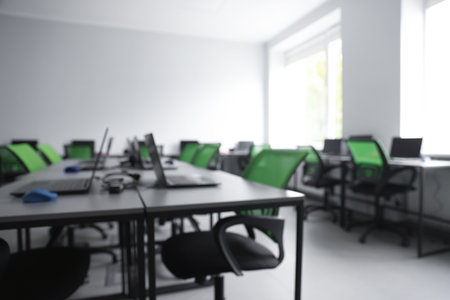 Blurred view of computer stylish class with laptops at schoolの写真素材