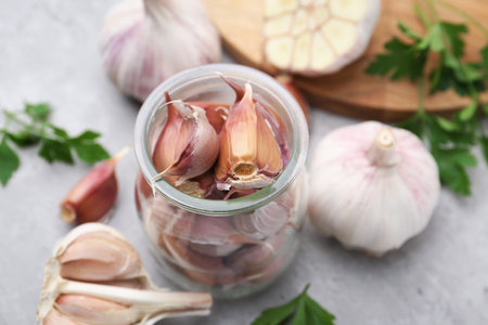 Garlic and parsley on light table, closeupの写真素材