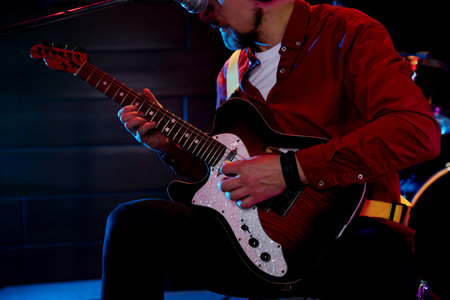 Man playing electric guitar on stage, closeupの写真素材