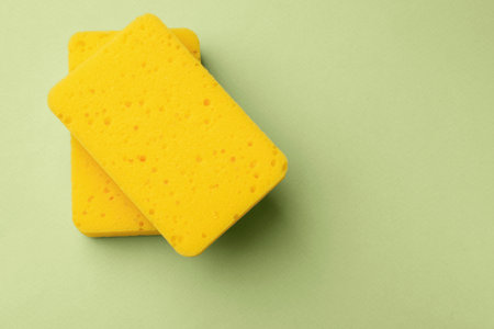 Kitchen sponges on light green background, top view. Space for textの写真素材