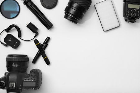 Professional photographer's equipment on white background, flat lay. Space for textの写真素材