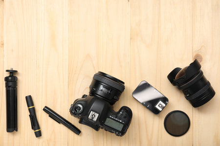 Professional photographer's equipment on wooden background, flat lay. Space for textの写真素材