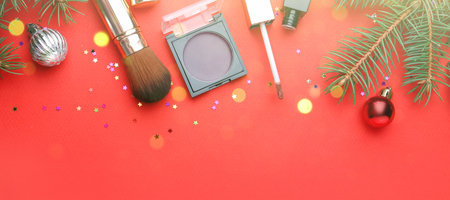 Christmas banner with fir tree branches and festive balls on red background, flat layの写真素材