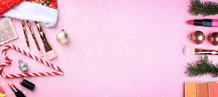 Christmas banner with fir tree branches and festive balls on pink background, flat layの写真素材