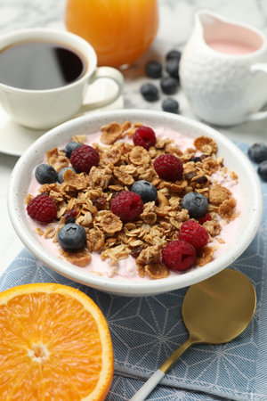 Tasty breakfast. Granola with yogurt and fruits served on table, closeup