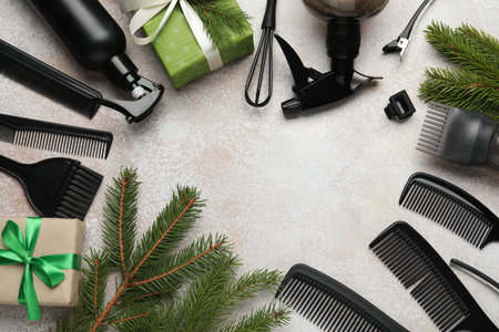 Hairdresser's tools and Christmas decor on color textured table, flat lay. Space for textの写真素材
