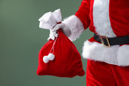 Santa Claus with sack on gray background, closeup. Merry Christmas and Happy New Yearの写真素材