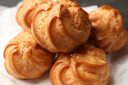 Delicious golden profiteroles on table, closeup viewの写真素材