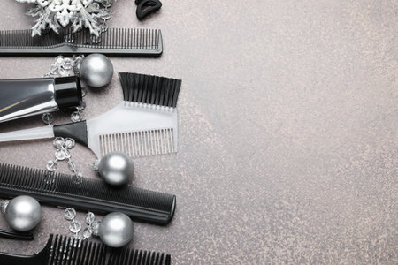 Hairdresser's tools and Christmas decor on gray table, flat lay. Space for textの写真素材