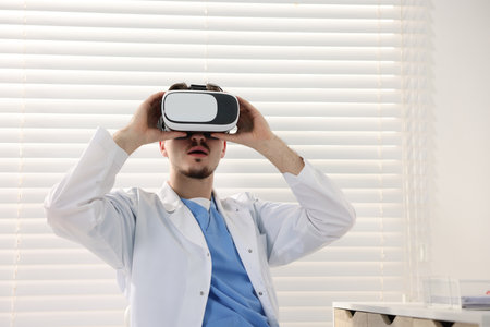 Modern technology. Doctor using virtual reality headset in office. Space for textの写真素材