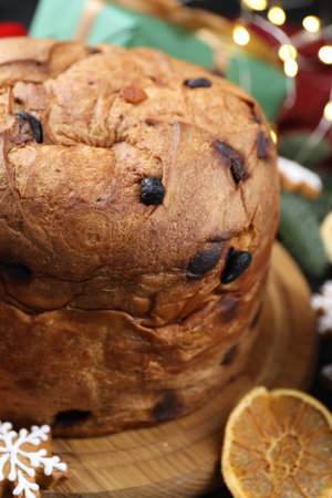 Tasty Christmas panettone cake with gingerbread cookie and dry orange slice on table, closeupの写真素材
