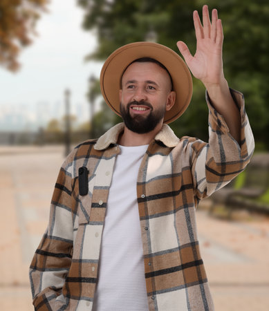 Man waving hand to someone outdoorsの写真素材