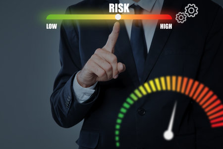 Man regulating level of risk on virtual screen with scale against gray background, closeupの写真素材