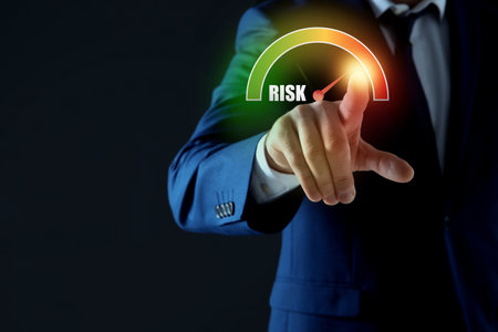 Man regulating level of risk on virtual screen against black background, closeupの写真素材