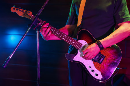 Man playing electric guitar on stage, closeupの写真素材