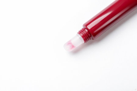Beautiful dark red lip gloss on white background, top view. Space for textの写真素材