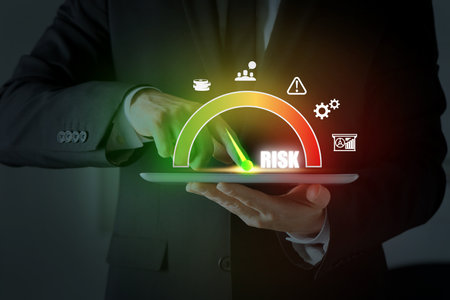 Man regulating the level of risk on tablet computer, closeup. Virtual scale and iconsの写真素材