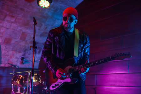 Man playing electric guitar on stageの写真素材