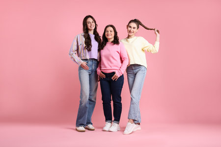 Portrait of happy friends on pink backgroundの写真素材