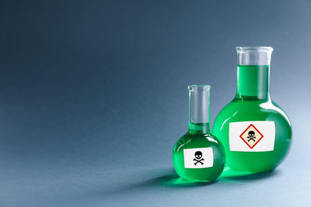 Laboratory glassware with warning labelsの写真素材