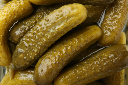 Pickled cucumbers in brine as background, closeupの写真素材