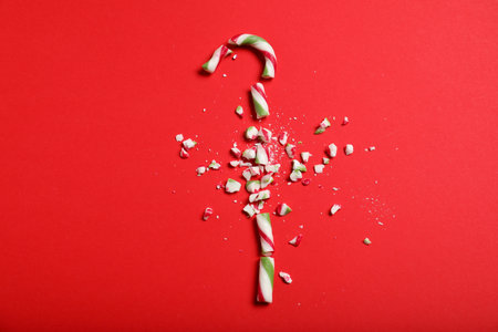 Crushed candy cane on red background, flat lay. Christmas treatの写真素材
