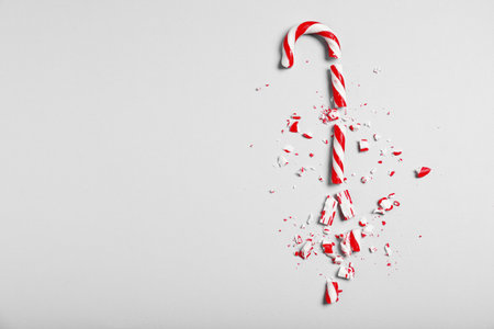 Crushed candy cane on gray background, flat lay with space for text. Christmas treatの写真素材