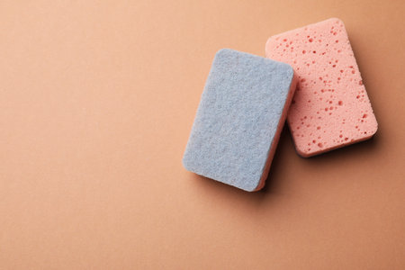 Kitchen sponges on brown background, top view. Space for textの写真素材