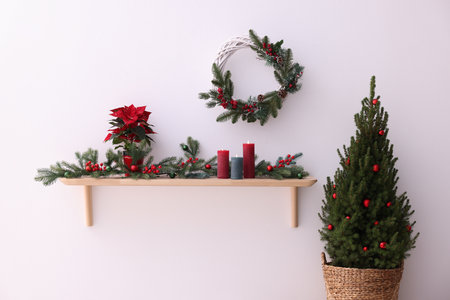 Stylish room with small spruce tree and Christmas decor. Interior designの写真素材