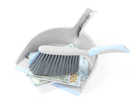 Dustpan with broom and dollar banknotes on white backgroundの写真素材