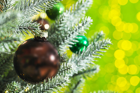 Beautiful ornaments on Christmas tree against light green background with blurred lights, closeup and space for text. Bokeh effectの写真素材