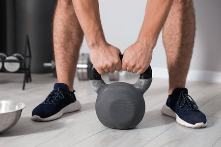 Strong man exercising with kettlebell in gym, closeupの写真素材