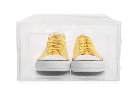 Pair of sneakers in plastic box on white background. Shoe storageの写真素材