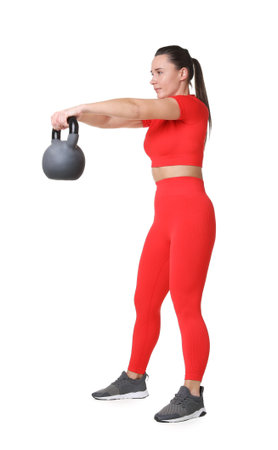 Athletic woman exercising with kettlebell on white backgroundの写真素材