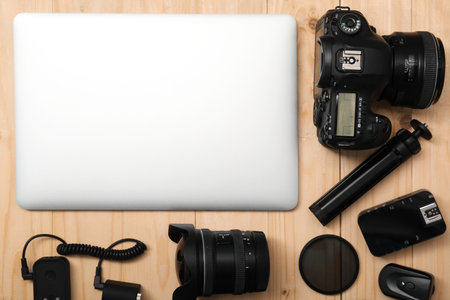 Professional photographer's equipment on wooden background, flat lay