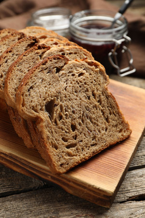 Bread slices with jam on wooden table