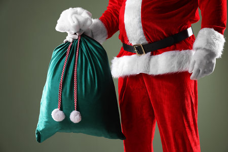 Santa Claus with sack on gray background, closeup. Merry Christmas and Happy New Yearの写真素材